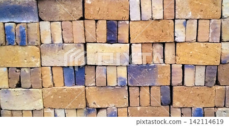 A stack of yellow clay bricks A stack of yellow clay bricks 142114619