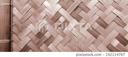 A reddish-brown woven bamboo textured background with a frame. A reddish-brown woven bamboo textured background with a frame. 142114767