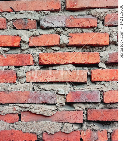 Rough red brick wall texture with traces of cement mortar. Rough red brick wall texture with traces of cement mortar. 142115036