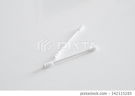 Two cotton swabs placed on a white table 142115285