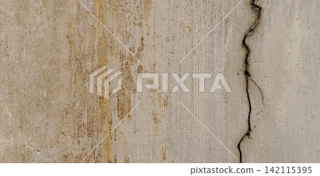 Weathered concrete wall with vertical cracks and rust stains. Weathered concrete wall with vertical cracks and rust stains. 142115395