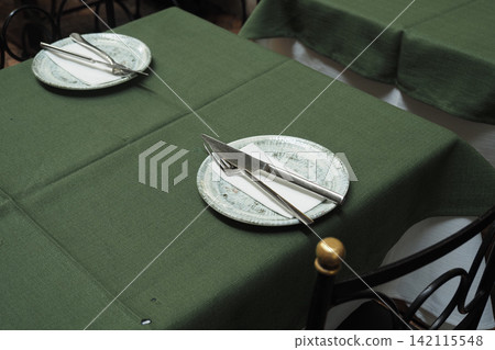 Tables are set with plates and utensils for dining Tables are set with plates and utensils for dining 142115548
