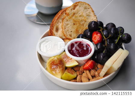 Breakfast spread with fruits, nuts, and bread Breakfast spread with fruits, nuts, and bread 142115553