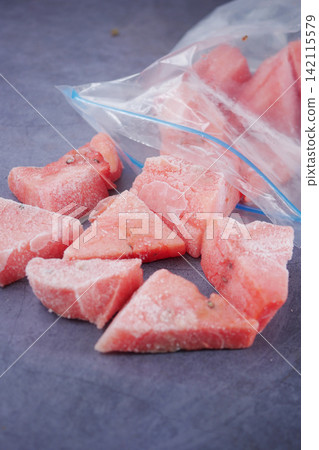 Frozen watermelon pieces in a plastic bag on a table 142115579