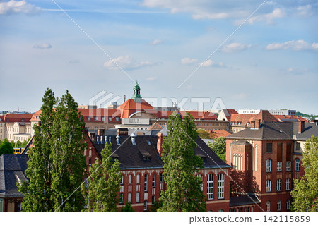 Historic red brick buildings and city rooftops under blue sky Historic red brick buildings and city rooftops under blue sky 142115859