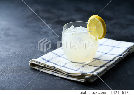 A glass of homemade lemonade on the dark kitchen table. Copy space for text. 142116173