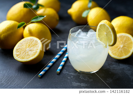 Refreshing homemade summer lemonade in glass with ice on a black table, selective focus. Cold refreshing lemonade . Refreshing homemade summer lemonade in glass with ice on a black table, selective focus. Cold refreshing lemonade . 142116182