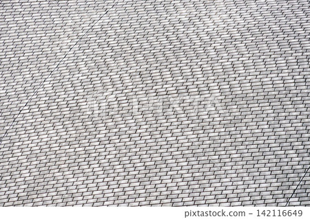 A wall texture with small white tiles arranged in a regular pattern. A wall texture with small white tiles arranged in a regular pattern. 142116649