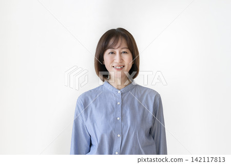 A woman in her early 50s smiling at the camera A woman in her early 50s smiling at the camera 142117813