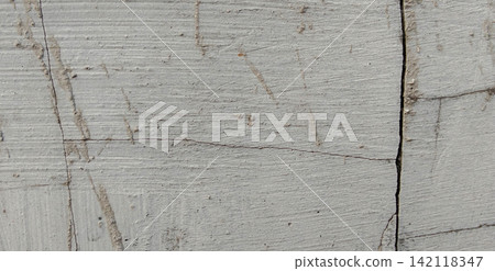 Light gray plaster surface with horizontal grooves and cracks. Light gray plaster surface with horizontal grooves and cracks. 142118347