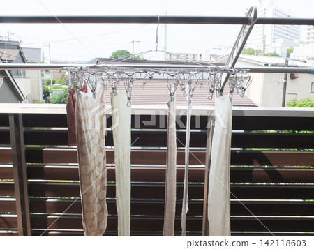 Laundry hanging on the balcony in the morning Laundry hanging on the balcony in the morning 142118603