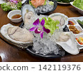 Fresh oysters with ice on wooden table in a restaurant, Thailand. 142119376