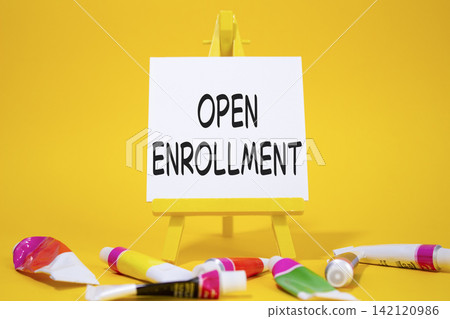Open Enrollment symbol. Wooden blocks with words Open Enrollment. Beautiful yellow background with paints and easel. Business and Open Enrollment concept. Copy space. Open Enrollment symbol. Wooden blocks with words Open Enrollment. Beautiful yellow background with paints and easel. Business and Open Enrollment concept. Copy space. 142120986