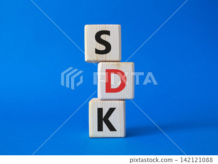 SDK - software development kit. Wooden cubes with word SDK . Beautiful blue background. Business and software development kit concept. Copy space. SDK - software development kit. Wooden cubes with word SDK . Beautiful blue background. Business and software development kit concept. Copy space. 142121088