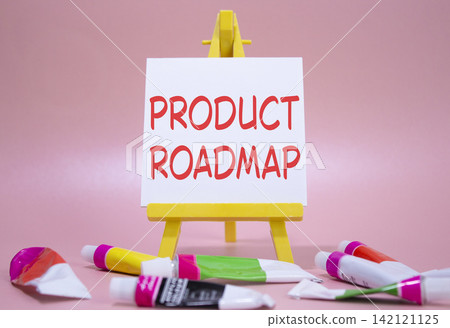 Product Roadmap symbol. Concept word Product Roadmap on wooden blocks. Beautiful pink background with paints and easel. Business and Product Roadmap concept. Copy space Product Roadmap symbol. Concept word Product Roadmap on wooden blocks. Beautiful pink background with paints and easel. Business and Product Roadmap concept. Copy space 142121125