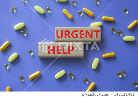 Urgent help symbol. Concept word Urgent help on wooden blocks. Beautiful purple background with pills. Medicine and Urgent help. Copy space Urgent help symbol. Concept word Urgent help on wooden blocks. Beautiful purple background with pills. Medicine and Urgent help. Copy space 142121491