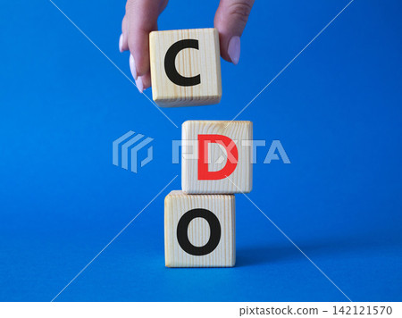 CDO - Collateralized Debt Obligation symbol. Wooden cubes with word CDO. Beautiful blue background. Businessman hand. Business and Collateralized Debt Obligation concept. Copy space. CDO - Collateralized Debt Obligation symbol. Wooden cubes with word CDO. Beautiful blue background. Businessman hand. Business and Collateralized Debt Obligation concept. Copy space. 142121570