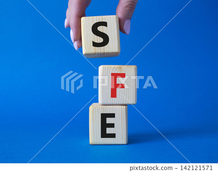 SFE - Sales Force Effectiveness. Wooden cubes with word SFE. Businessman hand. Beautiful blue background. Business and Sales Force Effectiveness concept. Copy space. SFE - Sales Force Effectiveness. Wooden cubes with word SFE. Businessman hand. Beautiful blue background. Business and Sales Force Effectiveness concept. Copy space. 142121571