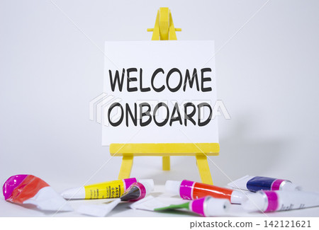 Welcome onboard symbol. Concept words Welcome onboard on wooden blocks. Beautiful white background with paints and easel. Business and Welcome onboard concept. Copy space. Welcome onboard symbol. Concept words Welcome onboard on wooden blocks. Beautiful white background with paints and easel. Business and Welcome onboard concept. Copy space. 142121621