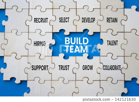 Build team symbol. Concept words build team on wooden puzzle pieces over blue background. Talent puzzle piece. Beautiful blue background. Team building concept. Copy space. Build team symbol. Concept words build team on wooden puzzle pieces over blue background. Talent puzzle piece. Beautiful blue background. Team building concept. Copy space. 142121630