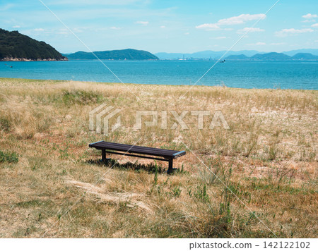 A bench overlooking the sea, Naoshima Island, Kagawa Prefecture, with a nostalgic negative film feel. A bench overlooking the sea, Naoshima Island, Kagawa Prefecture, with a nostalgic negative film feel. 142122102