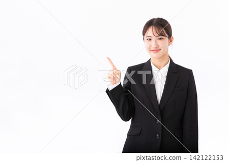 A young woman in a suit points her finger. A young woman in a suit points her finger. 142122153