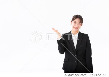 A young woman in a suit who was giving directions A young woman in a suit who was giving directions 142122156