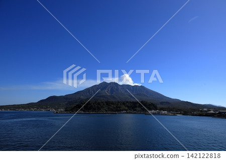 在湛藍的天空下,櫻島渡輪升起的白色煙霧一直延伸到櫻島。 在湛藍的天空下,櫻島渡輪升起的白色煙霧一直延伸到櫻島。 142122818