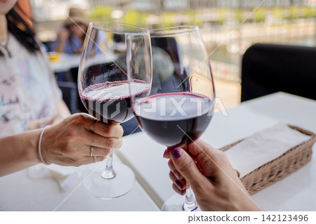 A toast with red wine A toast with red wine 142123496