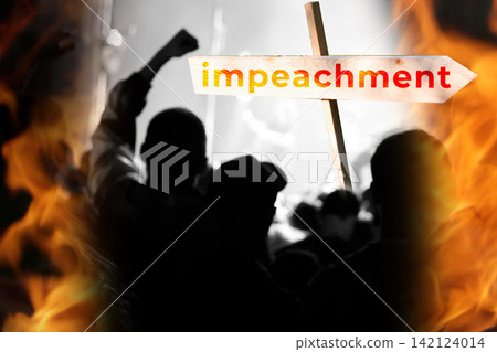 Wooden arrow sign with impeachment word in front of protesting crowd silhouettes with raised fists and burning flames. Crowd of activists with signs, impeachment concept, political conflict Wooden arrow sign with impeachment word in front of protesting crowd silhouettes with raised fists and burning flames. Crowd of activists with signs, impeachment concept, political conflict 142124014