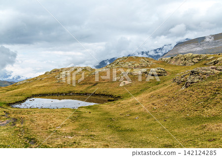 Hiking trail in Cirque de Troumouse at Heas in the Hautes-Pyrenees department in France, forming the border with Spain 142124285