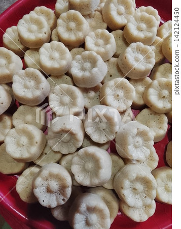 Traditional Indonesian Steamed Flower Shaped Cakes Apem on Red Plate Traditional Indonesian Steamed Flower Shaped Cakes Apem on Red Plate 142124450