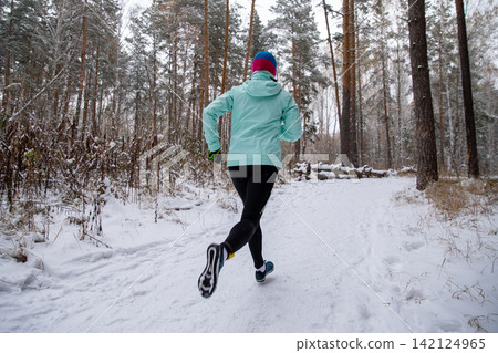 Rear view woman running trail Rear view woman running trail 142124965