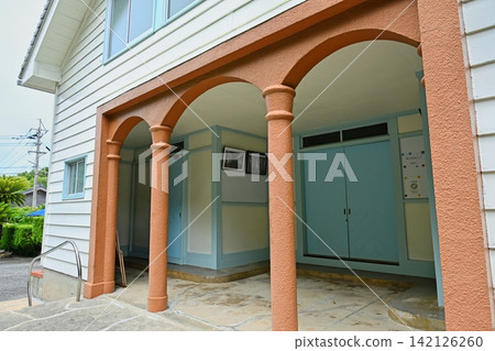 Kaizu Church, with its striking orange arch columns and pale blue doors. Kaizu Church, with its striking orange arch columns and pale blue doors. 142126260