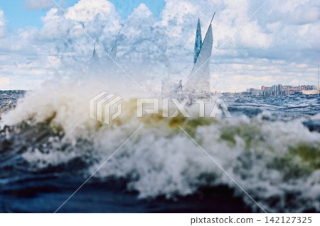 magic splashing water, Russia, St.Petersburg, Yachtsmen are sitting amicably on board of the sailing boat in sailing regatta in the Gulf of Finland at sunny day, teamwork magic splashing water, Russia, St.Petersburg, Yachtsmen are sitting amicably on board of the sailing boat in sailing regatta in the Gulf of Finland at sunny day, teamwork 142127325