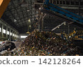 Industrial conveyor belt unloading processed organic waste pile in recycling power plant warehouse. 142128264