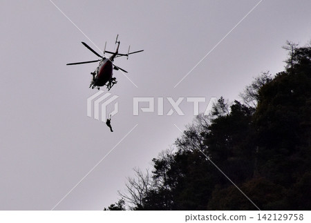 救援人員從直升機上下來 救援人員從直升機上下來 142129758