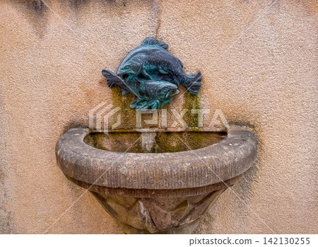 Fish sculpture on a wall shows artistic design Fish sculpture on a wall shows artistic design 142130255
