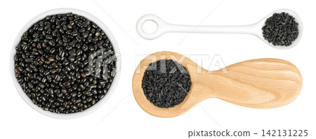 Black bean or Urad dal, black gram, vigna mungo in ceramic bowl and spoon isolated on the white background. Top view. Flat lay. Black bean or Urad dal, black gram, vigna mungo in ceramic bowl and spoon isolated on the white background. Top view. Flat lay. 142131225