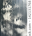 Leaves shadows on corrugated metal wall. Leaves reflection, sunlight and nature background 142131768