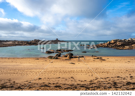 Sandy bay with granite reefs and tidal pools in Tregastel, France Sandy bay with granite reefs and tidal pools in Tregastel, France 142132042