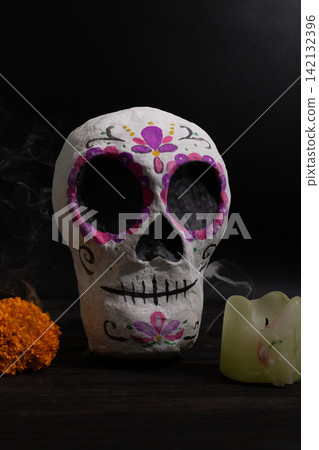 Day of the Dead decorative sugar skull centerpiece in papier mache with marigold and candle 142132396