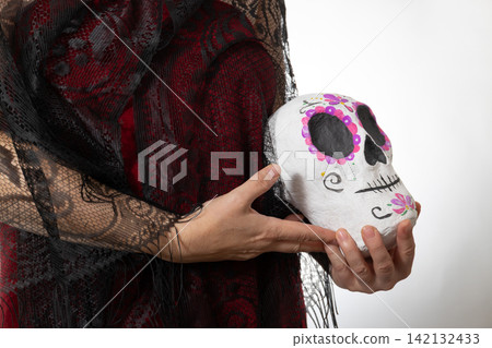 Dia de los Muertos Reverent Woman with Hand-Painted Sugar Skull in Studio Copy Space Dia de los Muertos Reverent Woman with Hand-Painted Sugar Skull in Studio Copy Space 142132433