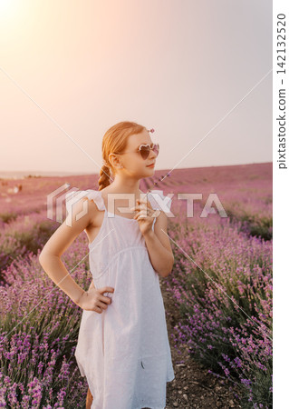 Lavender girl summer, young girl in white dress holding flower in a purple lavender field at sunset with soft lighting Lavender girl summer, young girl in white dress holding flower in a purple lavender field at sunset with soft lighting 142132520