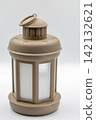 Beige indoor lantern with handle closeup on white. 142132621