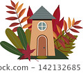 A cozy vector illustration of a tall fairytale house with beige walls, an arched door, and a round window under a gray roof. The building is surrounded by a composition of colorful autumn leaves, bran 142132685