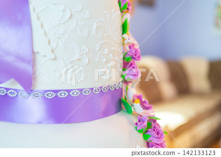 wedding cake decoration. beautiful wedding cake with purple orchids. cake in violet tones 142133123