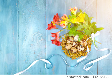 Spring background. Bouquet of flowers on a wooden background and a nest with eggs. spring Spring background. Bouquet of flowers on a wooden background and a nest with eggs. spring 142133129