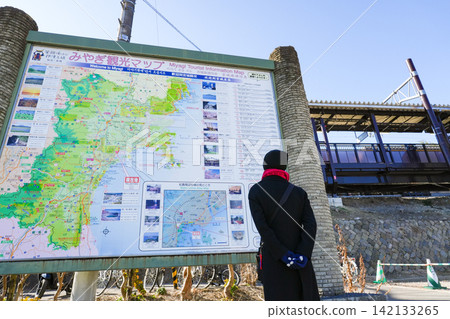 A traveler's back as they look at a Miyagi Prefecture tourist map. A traveler's back as they look at a Miyagi Prefecture tourist map. 142133265