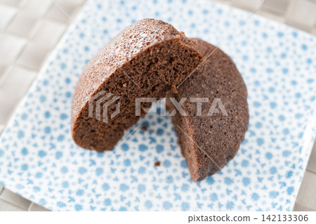 Close-up of a cross-section of a fluffy chocolate steamed bun. Close-up of a cross-section of a fluffy chocolate steamed bun. 142133306